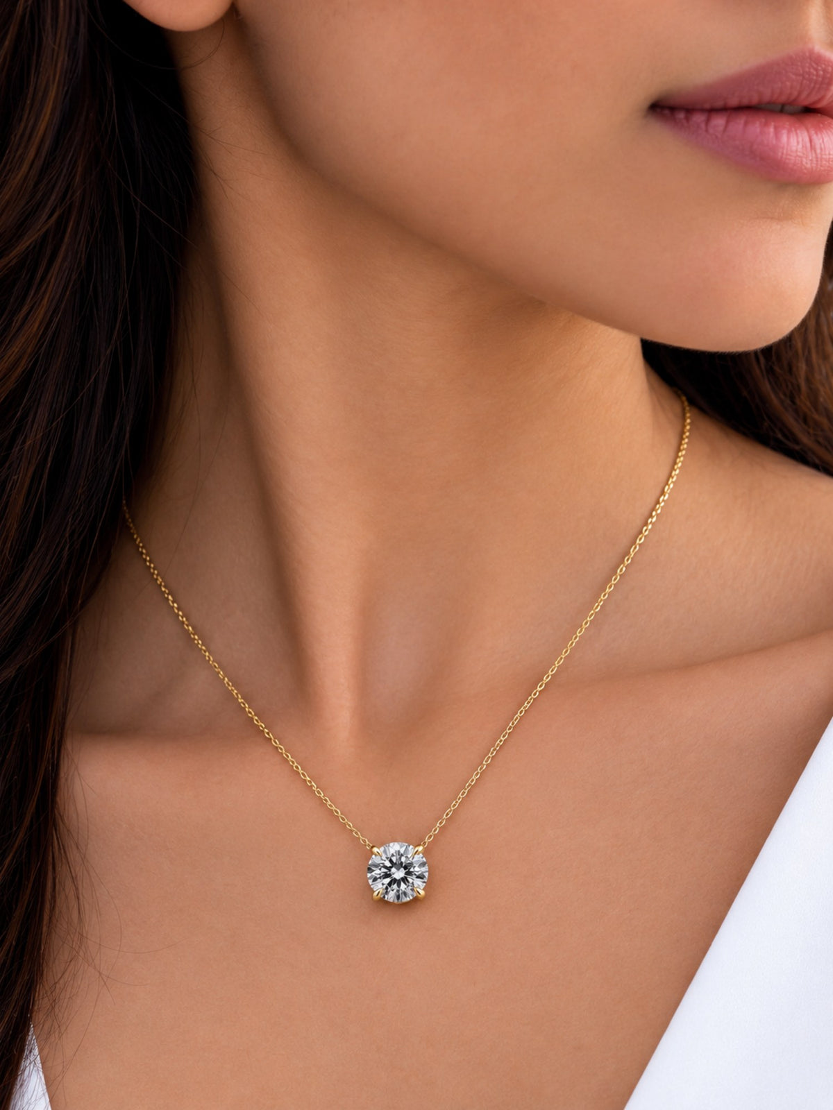 Diamond solitaire pendant on a fine gold chain, worn