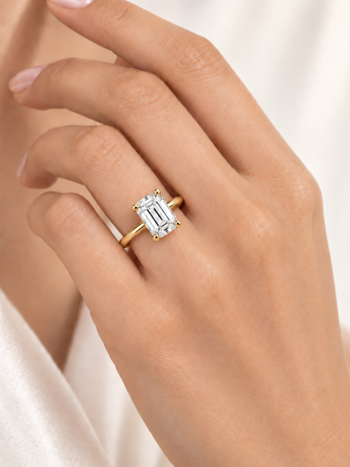 Emerald cut lab diamond ring worn on hand